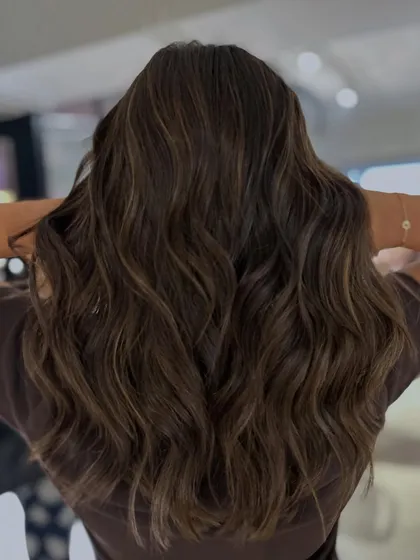 A classic two-tone mocha and beige highlight blend on mid-length to long hair. The long layers haircut adds texture and movement, beautifully showcasing the color.