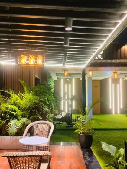 Another view from the seating nook, looking towards the outdoor gym space, highlighting the integrated lighting in the pergola ceiling.