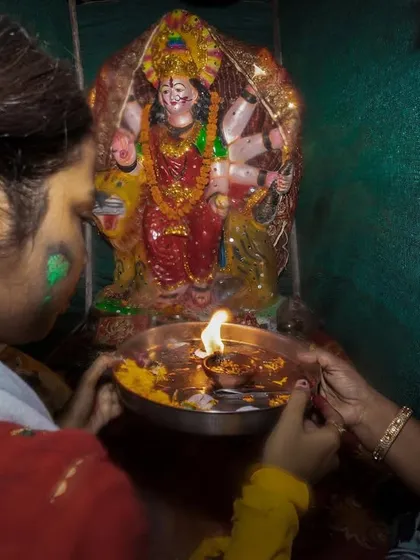 Devotees perform aarti for a goddess idol before its immersion during a Visarjan ceremony in Delhi.