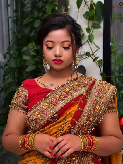 A beauty-focused shot with the model's eyes closed, drawing attention to the colorful eyeshadow and flawless makeup application.