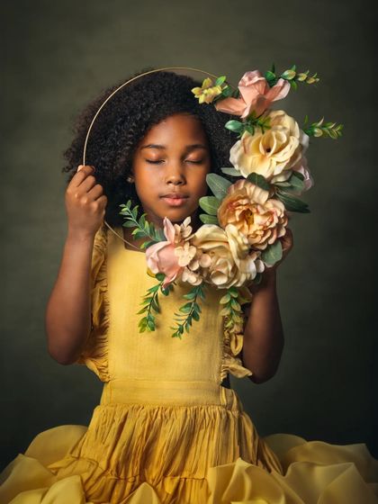 A solo portrait of young Naomi from her family session. Holding a floral wreath, she looks serene and angelic. This image shows that during a family shoot, I also take time to capture the individual personality of each child.