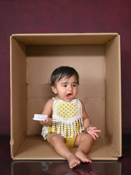 The many faces of a baby in a box! This one captures a moment of surprise and a big yawn.