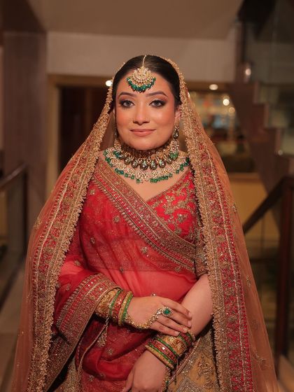 A full bridal look featuring a red lehenga with green-accented kundan jewellery. These images show how you can create a perfectly coordinated and stunning bridal look through my rental service.