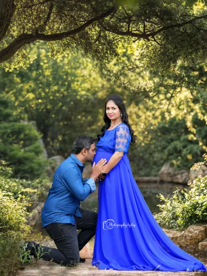 A stunning outdoor portrait in a royal blue gown. The lush greenery and natural setting provide a beautiful contrast, making the color pop.