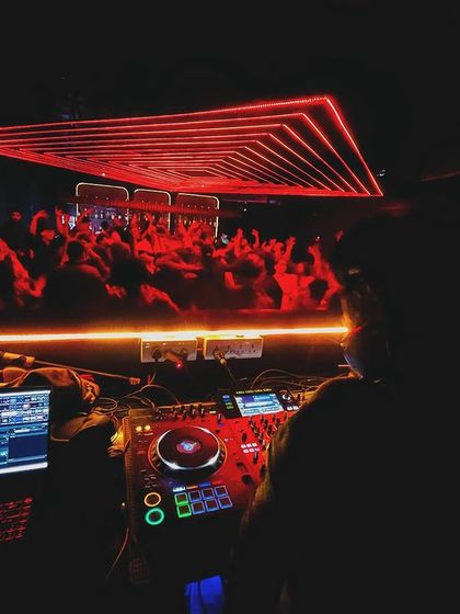 My perspective from the DJ booth at Unicorn House, looking out at the red-lit dance floor.