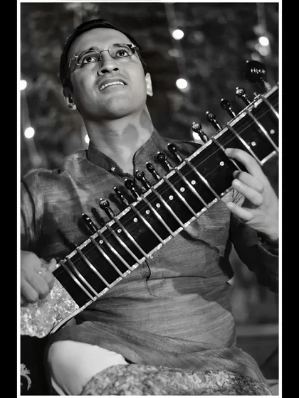 Looking upwards, immersed in the music, in this black and white performance photo.
