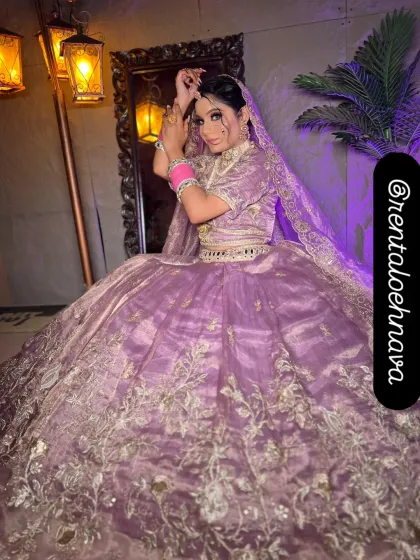 For the modern bride, I offer pastel options like this beautiful lilac organza lehenga. It's detailed with delicate silver floral embroidery, ideal for a day wedding or Anand Karaj ceremony.
