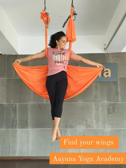 Find your wings with us. An instructor demonstrates a beautiful, open-hearted pose in the aerial hammock.