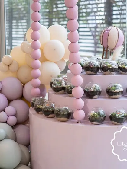 Another view of the terrarium favor station, showing how it doubles as a stunning piece of decor.