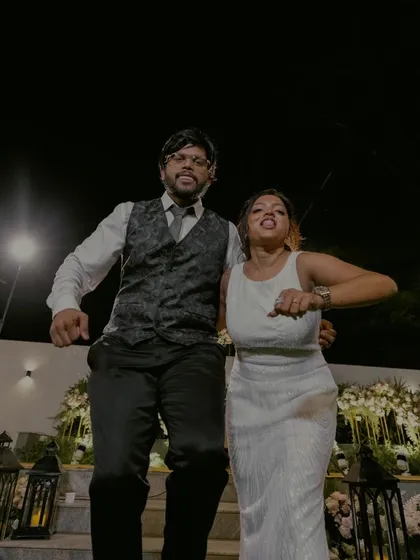 Pure joy and energy as the couple dances during their engagement celebration, captured in a fun, low-angle shot.