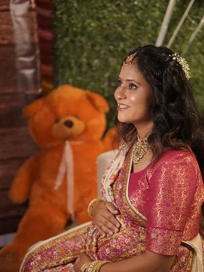A solo portrait of the mom-to-be at her baby shower. She looks serene and beautiful, surrounded by festive decorations.