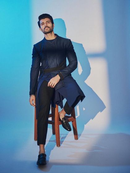 Vijay Deverakonda at the 'Kushi' trailer launch in a modern, deconstructed ethnic look by Unit by Rajat Suri. The asymmetrical lines and belted waist create a unique and fashion-forward silhouette.
