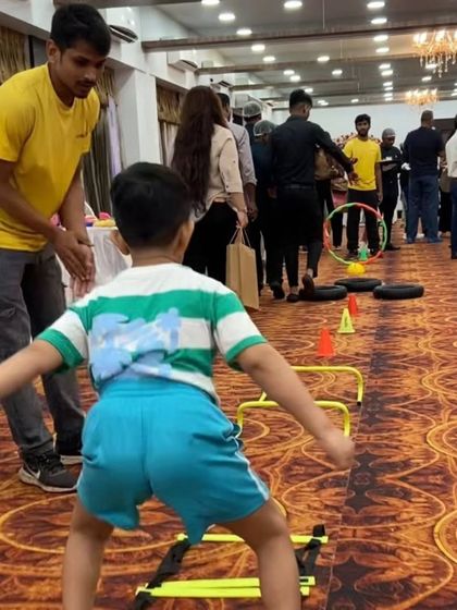A young boy tackles the mini hurdles during an indoor party. Our equipment is versatile and safe for use on various surfaces, from turf to carpeted halls.