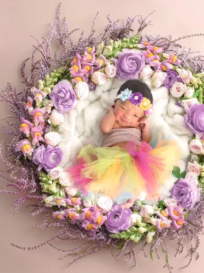 A different setup from the same shoot, with the baby in a floral wreath.