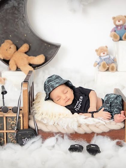 Dreaming on a cloud. This imaginative setup features a crescent moon, fluffy clouds, and a sky full of teddy bears, creating a magical scene for your sleeping baby.
