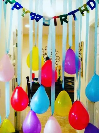 A classic and colorful doorway decoration. I use a 'Happy Birthday' banner and hanging balloons with ribbons to create a fun entrance for the guest of honor.