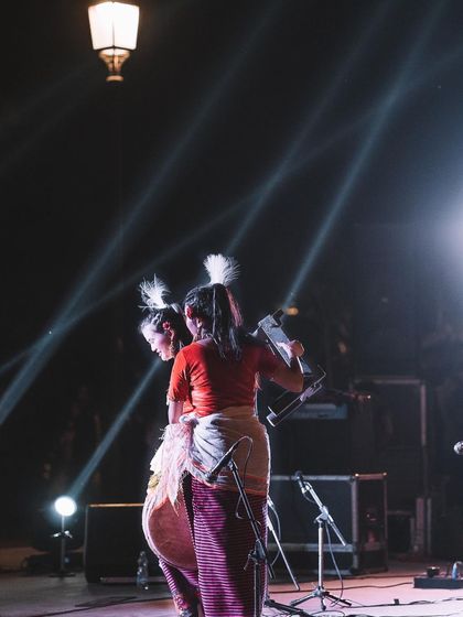 Performers on stage are silhouetted against dramatic beams of light. I love playing with light and shadow to create visually striking, abstract compositions during events.