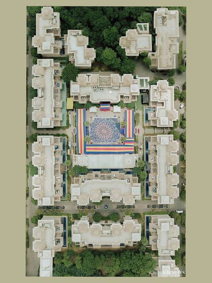 An aerial drone shot of the venue for a pool party, showing the grand scale and beautiful layout of the resort.