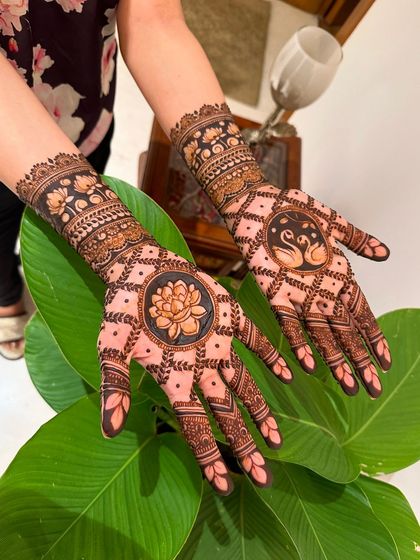 A clearer view of the lotus and swan motifs, showcasing the clean lines and careful shading that bring these traditional symbols to life.