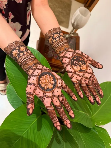 A clearer view of the lotus and swan motifs, showcasing the clean lines and careful shading that bring these traditional symbols to life.