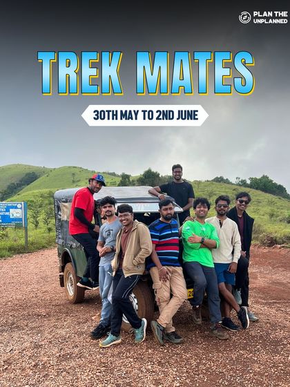A group of friends posing with their jeep, a key part of the adventure on treks like Kudremukha.