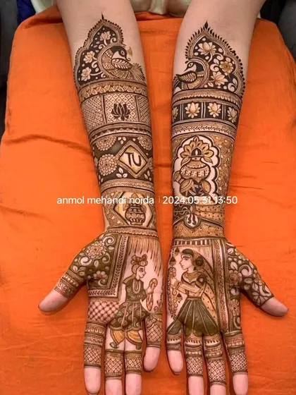 This intricate design for a bride features detailed figures of a bride and groom. The surrounding patterns include traditional motifs like a kalash (ceremonial pot) and peacocks, telling a complete wedding story on the arms.