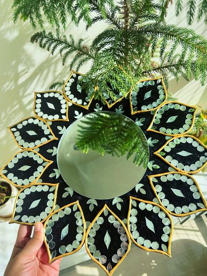 A unique take on traditional craft, this is a finished Mirror Lippan Art piece with intricate patterns and mirror work.