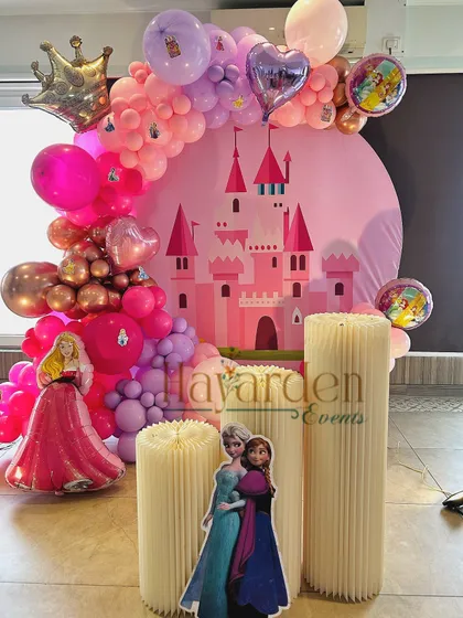 A fairytale come true with this Disney Princess theme. I used a castle-themed circular backdrop, character cutouts of Elsa, Anna, and Aurora, and a lush balloon garland in shades of pink and purple. It’s the perfect magical setting for your little princess.