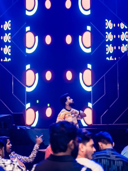 On stage at Sunburn Union, with the club's signature geometric visuals lighting up the screen behind me.