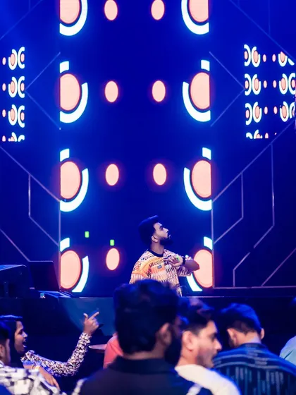 On stage at Sunburn Union, with the club's signature geometric visuals lighting up the screen behind me.