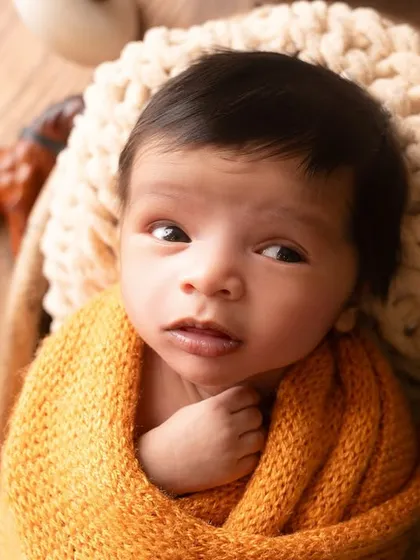 A beautiful awake moment, with the newborn's curious eyes open and looking around. I capture these quiet moments of observation with the same care as the sleepy poses.