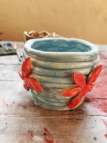Look at these beautiful little wares from a beginner's course. She created a lovely marbled mug, a textured vase, and a carved luminary with a rich, rustic glaze.