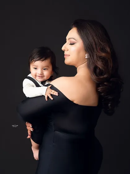 A mother's loving gaze at her little boy, dressed up smartly in his bow tie.