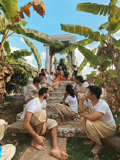Students gather at the steps of our outdoor shrine for a philosophy lesson. Learning in nature helps to integrate the teachings in a more profound and embodied way.