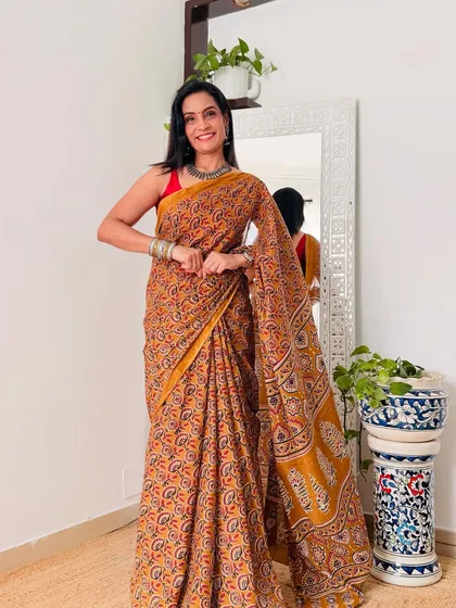 This mustard yellow cotton Mulmul saree with a classic block print is a versatile and stylish choice for any day.
