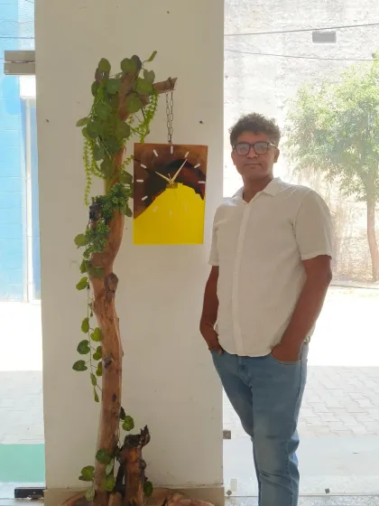 Here I am standing next to one of my wood and yellow resin clocks, displayed on a custom-made wooden stand. It shows how my art can be integrated into larger decor pieces.