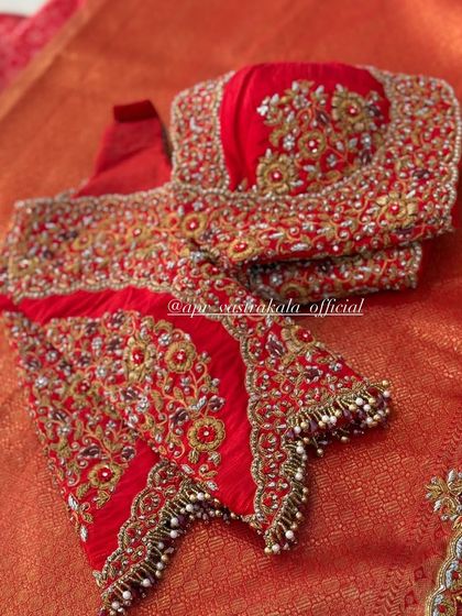 The sleeves of the red bridal blouse, featuring a mix of textures and embroidery.