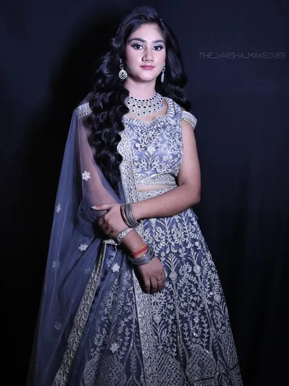 A full-length shot of the grey embroidered lehenga, showcasing its elegant design and intricate silver threadwork.