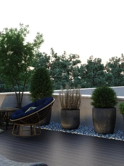 This angle showcases a more intimate seating nook on the terrace, with comfortable chairs set against a backdrop of potted plants and trees. It demonstrates how we create multiple zones within a single outdoor space for different activities.