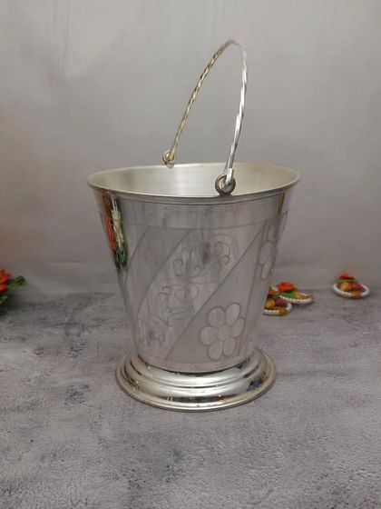 A German silver bucket, beautifully designed and available in various sizes. It can be used for holding flowers or holy water.