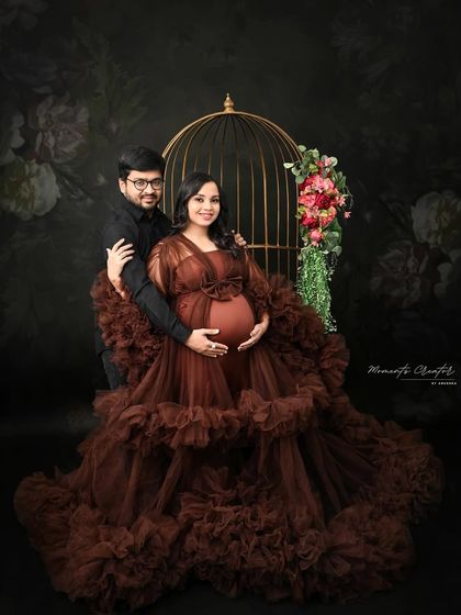 A classic couple's portrait featuring my golden birdcage prop. The prop adds a touch of vintage elegance to this shot against a floral background.
