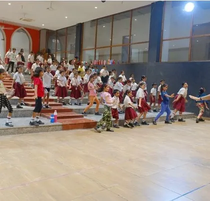 Bringing the energy to a school workshop. I love conducting these large sessions, making sure every single student is engaged and moving. It's all about simple, fun choreography that gets everyone excited about dance.