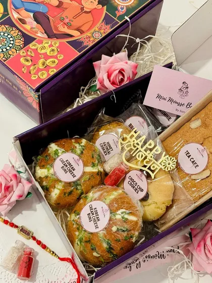 This is my Hamper 1 for Rakhi, featuring a mix nuts tea cake, choco chunk brownies, Korean cream cheese buns, and honey oat cookies. It's a perfectly balanced box of treats for the occasion.