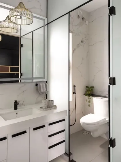 This walk-in closet and vanity area exudes luxury. I used a combination of black tinted glass sliding wardrobes and a bright, white vanity with marble-patterned walls to create a sophisticated and highly functional dressing space.