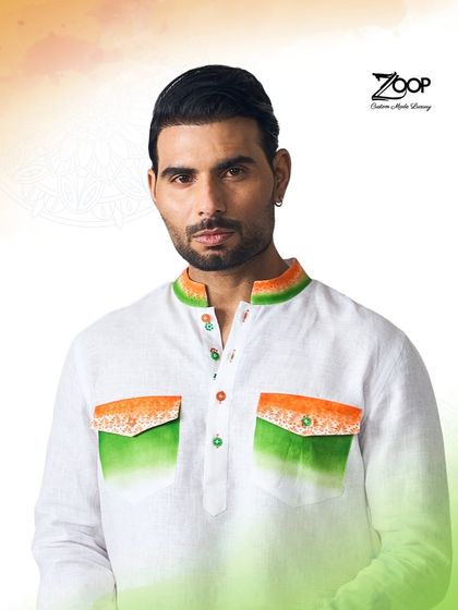 A unique take on patriotic fashion. This white kurta features ombre green and saffron on the pockets and collar, blending national pride with contemporary style.