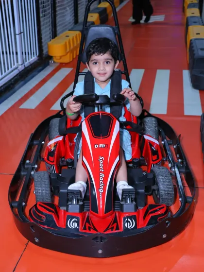 Another happy racer ready to start his engine. Our go-karts are a hit with kids who love speed and friendly competition.