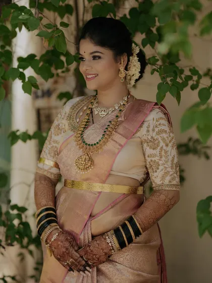 A beautiful smile from Gagana at her post-wedding reception. Her makeup is soft and romantic, with a focus on glowing skin.