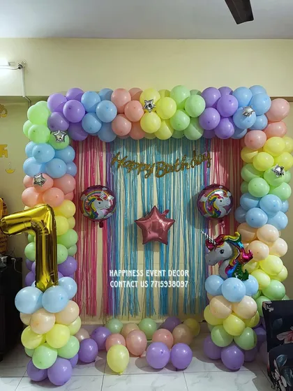 A clear, well-lit shot of the unicorn-themed home party decoration, showing the pastel color palette and shimmering curtain backdrop.