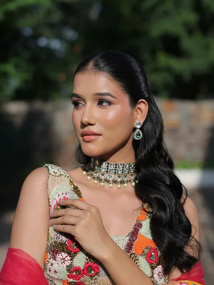 A side profile of the sunkissed Haldi look. The makeup is fresh and minimal, letting her natural beauty and the vibrant outfit shine.