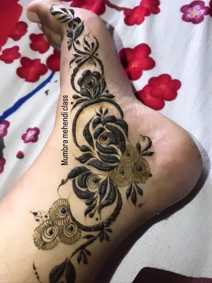 A gorgeous rose vine design that flows along the side of the foot. This is a very popular and elegant placement.